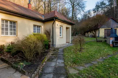 a house with a walkway in front of a yard at Apartman Lucie in Liběchov