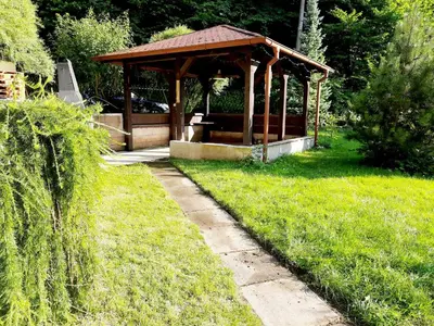 a wooden gazebo in a yard with grass at Apartman Lucie in Liběchov