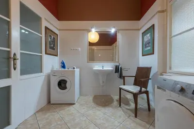 a bathroom with a washing machine and a sink at Liliova Apartments in Prague