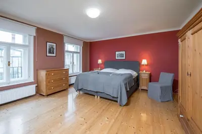 a bedroom with a bed and a red wall at Liliova Apartments in Prague