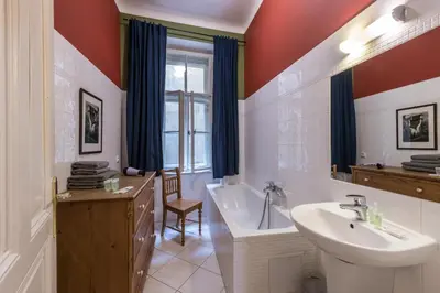 a bathroom with a tub and a sink and a bath tub at Liliova Apartments in Prague