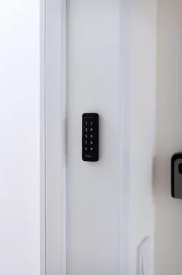 a white laundry room with a washing machine and a sink at City Haven Apartments in Prague