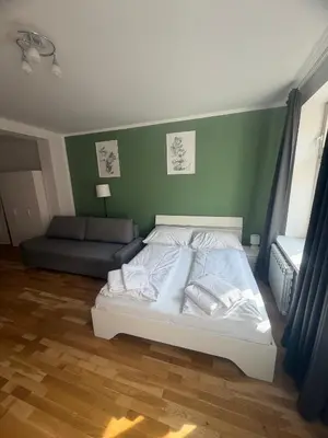 a gray couch with pillows in a living room at City Haven Apartments in Prague