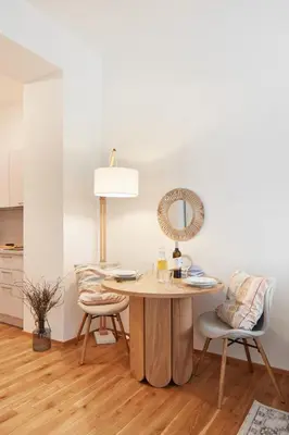 a table with a fan and two chairs in a room at Prague Days - Studio with Outdoor Seating close to Vyšehrad in Prague