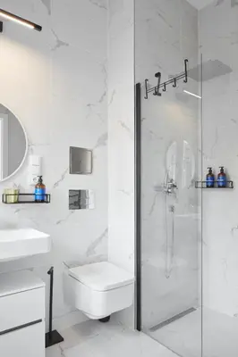 a white bathroom with a shower and a sink at Prague Days - Studio with Outdoor Seating close to Vyšehrad in Prague