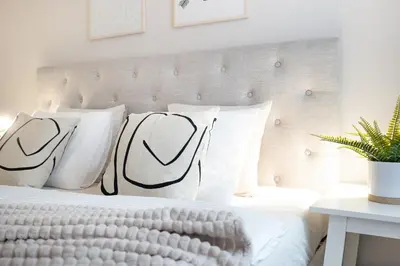 a white bed with black and white pillows at Negrelli Residence - main BUS station in Prague