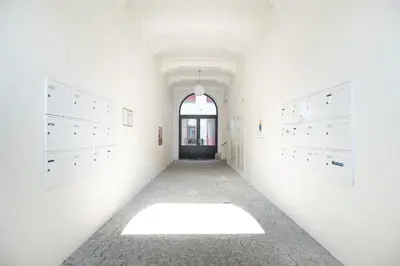 an empty hallway with white cabinets and a window at Negrelli Residence - main BUS station in Prague