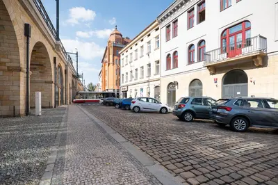 a row of cars parked on a cobblestone street at Negrelli Residence - main BUS station in Prague