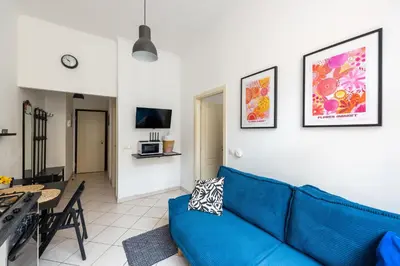a living room with a blue couch and a table at Tyrsova Apartment in Prague