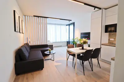 a living room with a couch and a table at Sunny Apartment in Smichov, Prague 5 in Prague