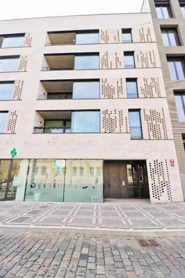 a large brick building with a door in front of it at Sunny Apartment in Smichov, Prague 5 in Prague