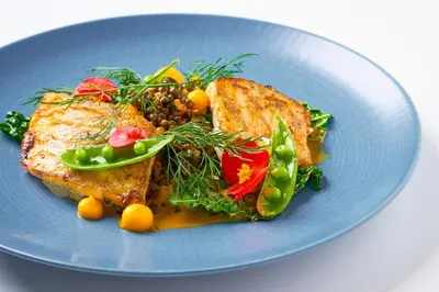 a blue plate of food with meat and vegetables at Prague City Golf Apartments in Prague