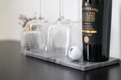 a bottle of wine and a golf ball on a table at Prague City Golf Apartments in Prague