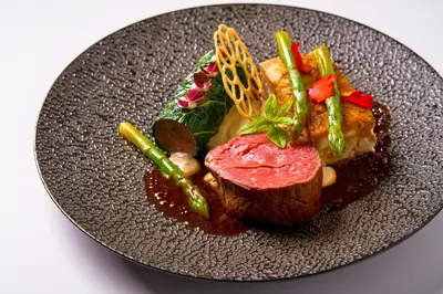a plate of food with meat and vegetables on it at Prague City Golf Apartments in Prague