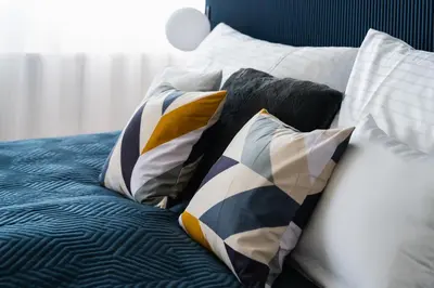 a bed with a bunch of pillows on it at Prague City Golf Apartments in Prague