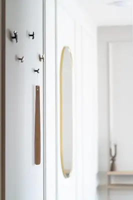 a white cabinet with a mirror on the door at Prague City Golf Apartments in Prague