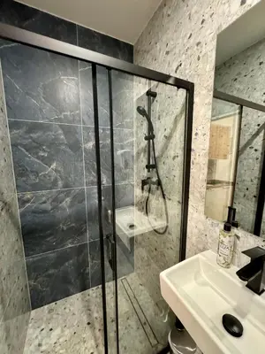 a bathroom with a shower and a sink at Zitna Downtown Apartments in Prague