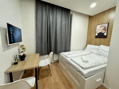 a small bedroom with a bed and a desk at Zitna Downtown Apartments in Prague