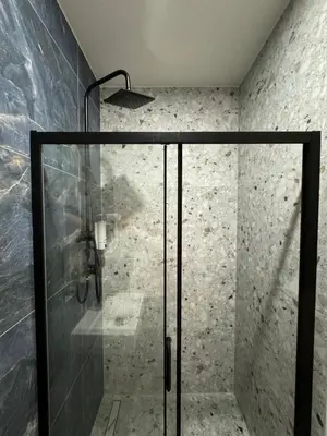 a shower with a glass door in a bathroom at Zitna Downtown Apartments in Prague