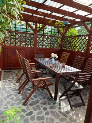 a wooden table and chairs on a patio at Cat’s House- Dům u třech koček in Zdice