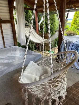 a swing on a porch with a bed at Cat’s House- Dům u třech koček in Zdice