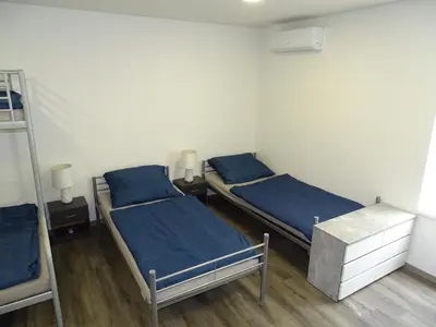 two beds in a room with blue sheets at Apartmán Nebužely in Nebužely
