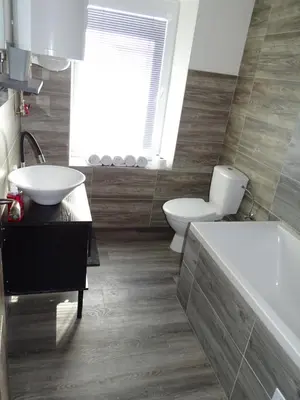 a bathroom with a toilet and a sink and a tub at Apartmán Nebužely in Nebužely