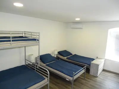 two bunk beds in a room with blue pillows at Apartmán Nebužely in Nebužely