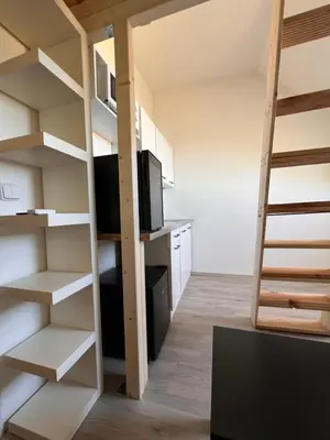 a small room with a bunk bed and a tv at Studio Prosecká vyhlídka in Prague