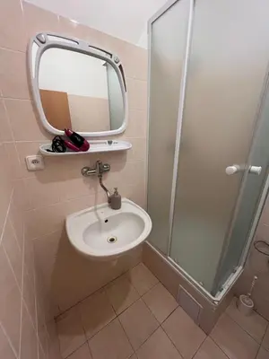 a bathroom with a sink and a shower with a mirror at Studio Prosecká vyhlídka in Prague