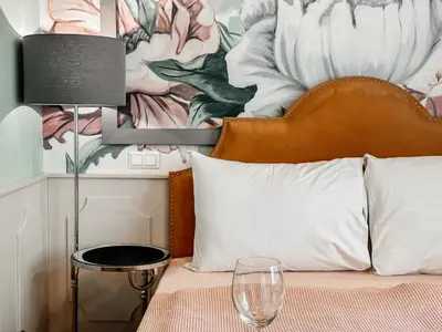 a bedroom with a bed with a flower mural at ELSO Muzeum apartments in Prague