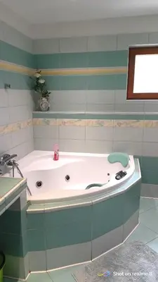 a bath tub in a bathroom with a sink at Apartmán Srubík in Čisovice