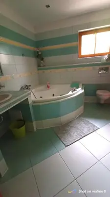 a bathroom with a tub and a sink and a toilet at Apartmán Srubík in Čisovice