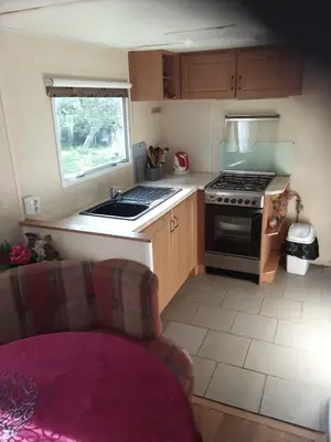 a small kitchen with a stove and a sink at Mobilní dům Venda in Hradištko