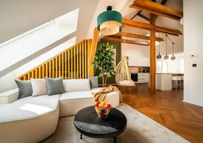 a living room with a white couch and a table at 3BR AC Heaven of Harmony LUXPenthouse Theater view in Prague