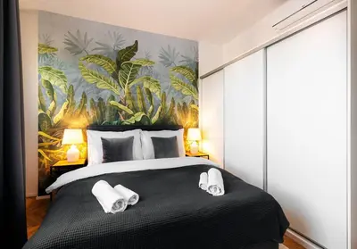 a bedroom with a large bed with towels on it at 3BR AC Heaven of Harmony LUXPenthouse Theater view in Prague