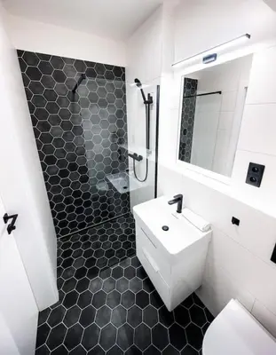 a white bathroom with a sink and a shower at 3BR AC Heaven of Harmony LUXPenthouse Theater view in Prague