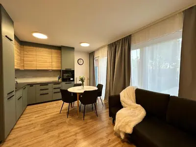 a living room with a couch and a table with chairs at IOS Garden in Prague