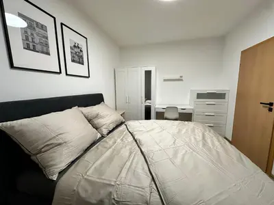 a bedroom with a bed and a desk at IOS Garden in Prague