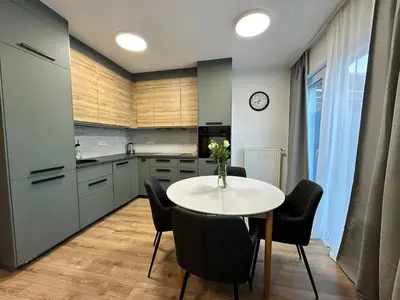 a kitchen with a table and chairs in a kitchen at IOS Garden in Prague