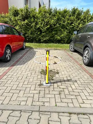 a car parked in a parking lot next to a pole at IOS Garden in Prague