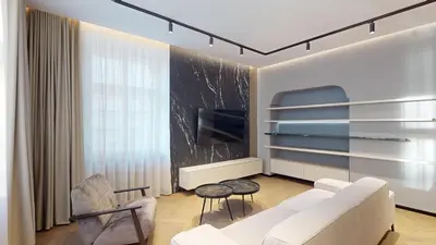a living room with a white couch and a tv at Naprstek Castle View Residence in Prague