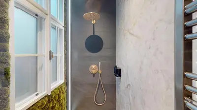 a shower in a bathroom with a window at Naprstek Castle View Residence in Prague