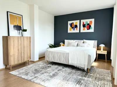 a bedroom with a white bed and a blue wall at 96m2 Designer Apartment, FREE Garage Parking in Prague