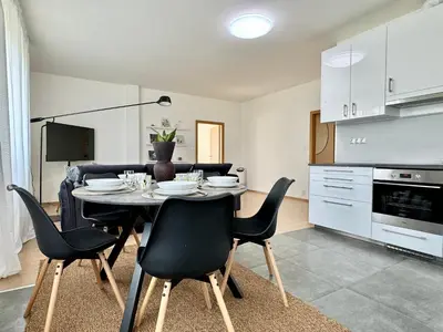 a kitchen and dining room with a table and chairs at 96m2 Designer Apartment, FREE Garage Parking in Prague