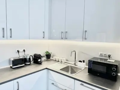 a kitchen with a sink and a microwave at 96m2 Designer Apartment, FREE Garage Parking in Prague