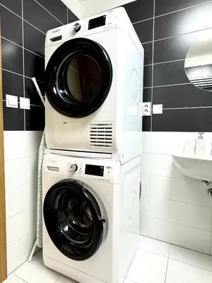 a washing machine and a dryer in a bathroom at 96m2 Designer Apartment, FREE Garage Parking in Prague