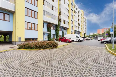 a street with cars parked in front of buildings at 96m2 Designer Apartment, FREE Garage Parking in Prague
