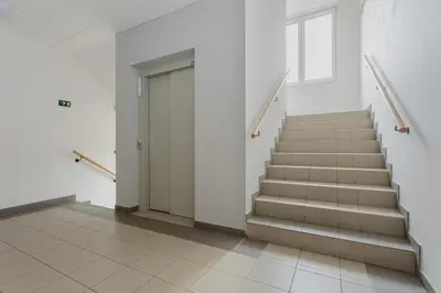 a hallway with stairs and a door in a building at 96m2 Designer Apartment, FREE Garage Parking in Prague