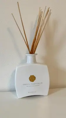 a white vase with sticks in it on a shelf at 布拉格城堡公寓 in Rudná